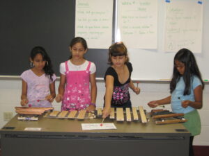 Children playing on homemade instruments